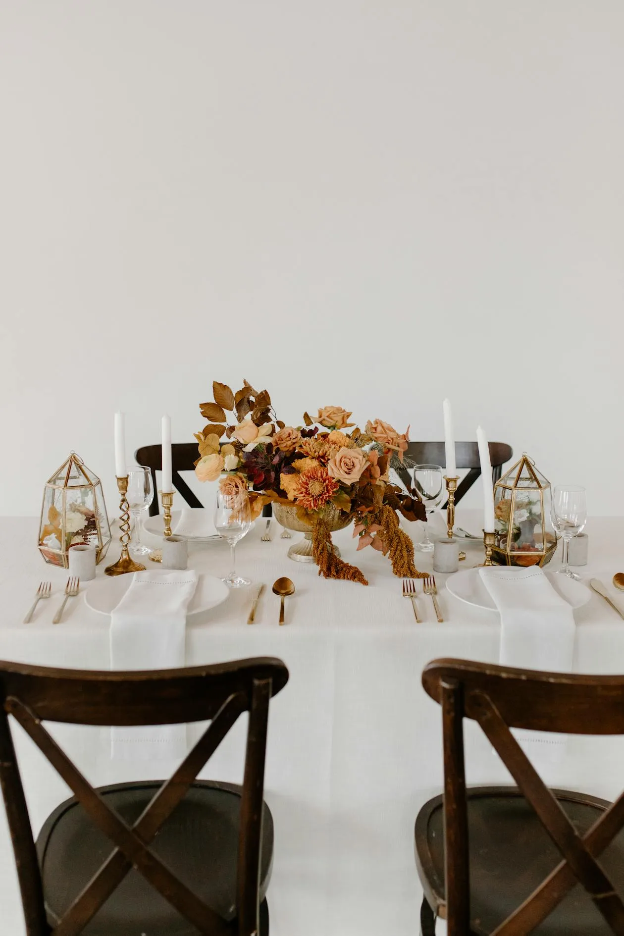 A festive table set with a flower bouquet and candles for a special dinner